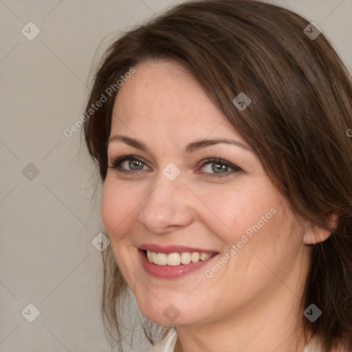 Joyful white adult female with medium  brown hair and brown eyes