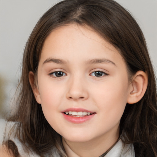 Joyful white child female with medium  brown hair and brown eyes