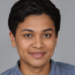 Joyful latino young-adult female with short  brown hair and brown eyes