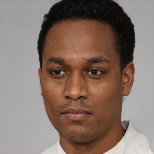 Neutral black young-adult male with short  black hair and brown eyes