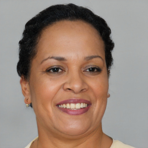 Joyful black adult female with short  brown hair and brown eyes