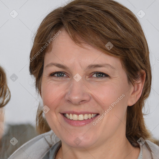 Joyful white young-adult female with medium  brown hair and blue eyes