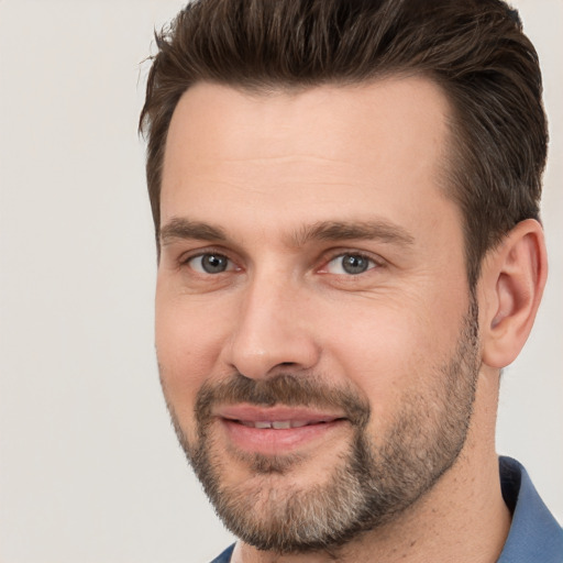 Joyful white adult male with short  brown hair and brown eyes