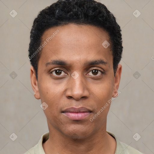 Joyful black young-adult male with short  black hair and brown eyes