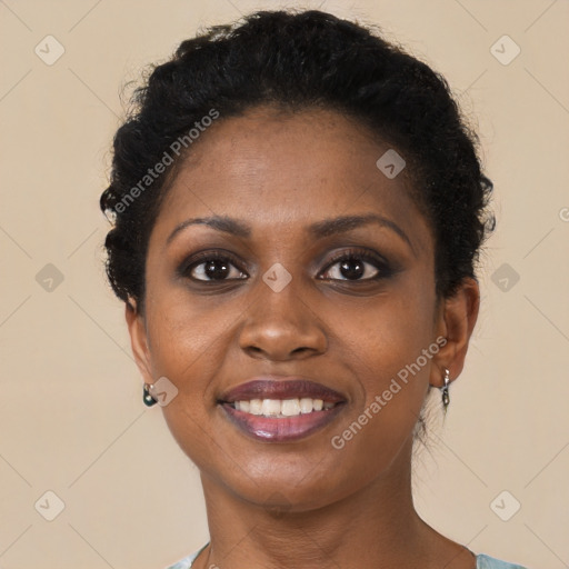 Joyful black young-adult female with short  brown hair and brown eyes