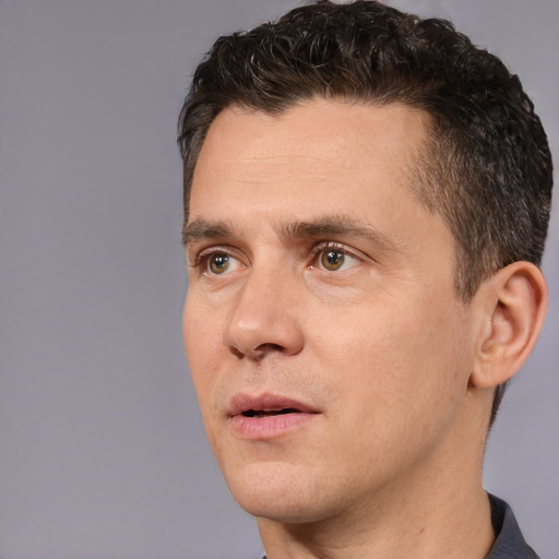 Joyful white adult male with short  brown hair and brown eyes