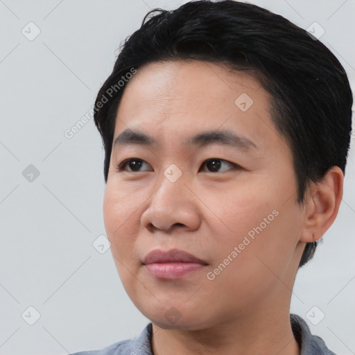 Joyful asian young-adult male with short  black hair and brown eyes