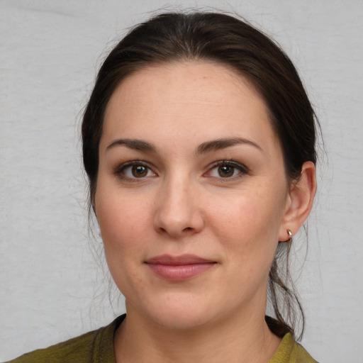 Joyful white young-adult female with medium  brown hair and brown eyes