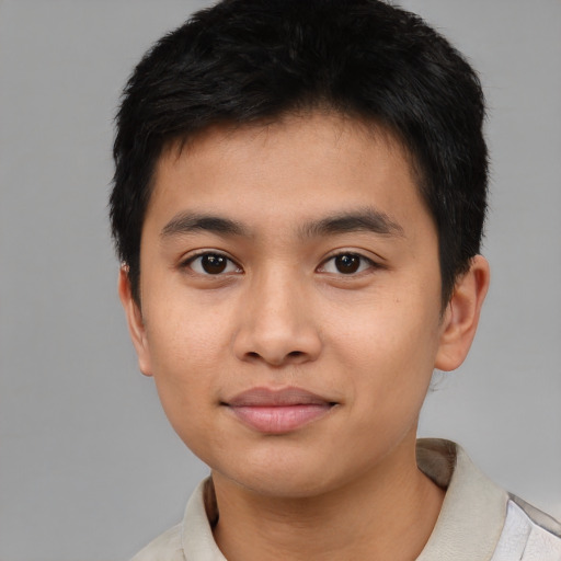 Joyful asian young-adult male with short  brown hair and brown eyes