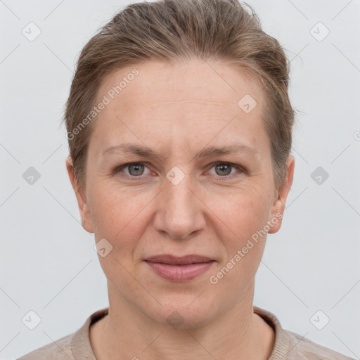 Joyful white adult female with short  brown hair and grey eyes