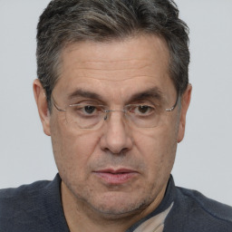 Joyful white middle-aged male with short  brown hair and brown eyes