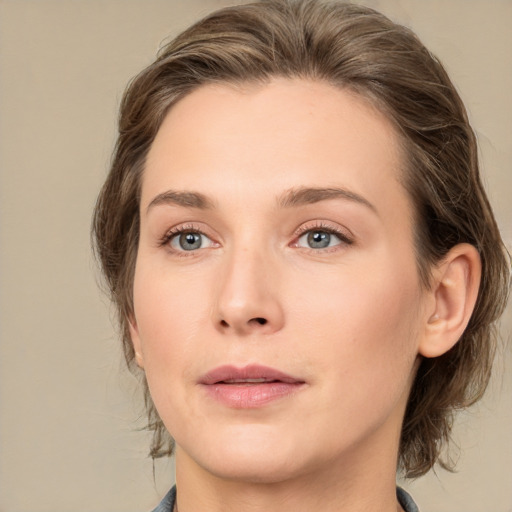 Joyful white young-adult female with medium  brown hair and green eyes