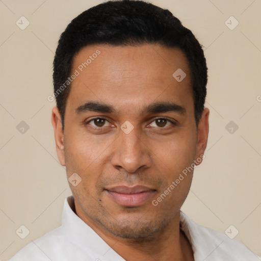 Joyful latino young-adult male with short  black hair and brown eyes