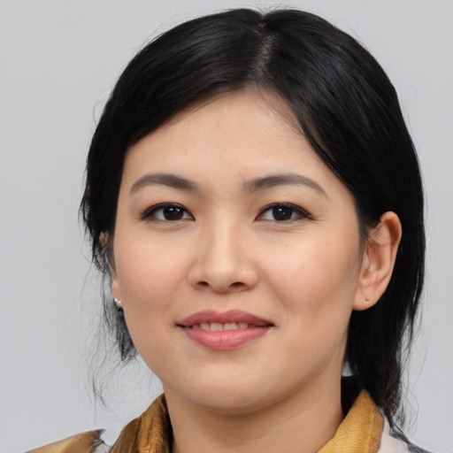 Joyful asian young-adult female with medium  black hair and brown eyes