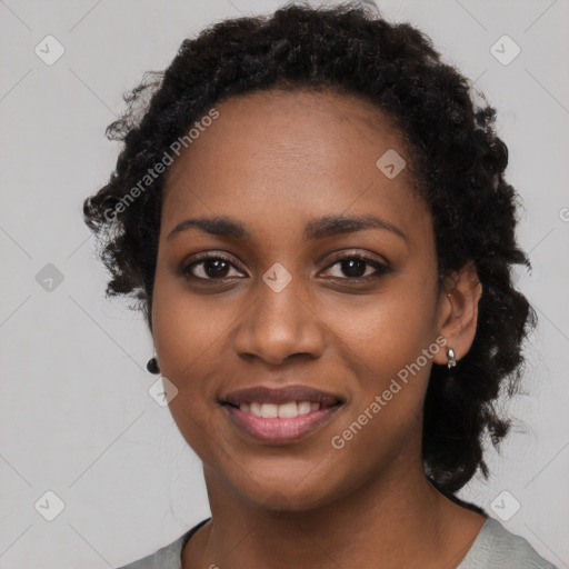 Joyful black young-adult female with long  black hair and brown eyes