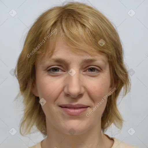 Joyful white adult female with medium  brown hair and blue eyes