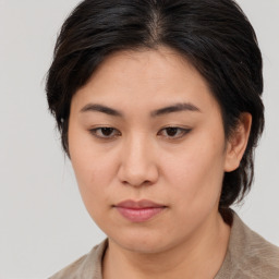 Joyful asian young-adult female with medium  brown hair and brown eyes