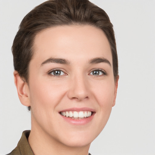 Joyful white young-adult female with short  brown hair and grey eyes