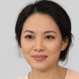 Joyful asian young-adult female with medium  brown hair and brown eyes