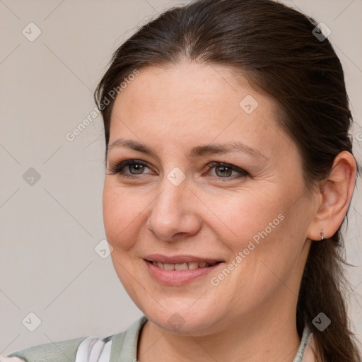 Joyful white adult female with medium  brown hair and grey eyes