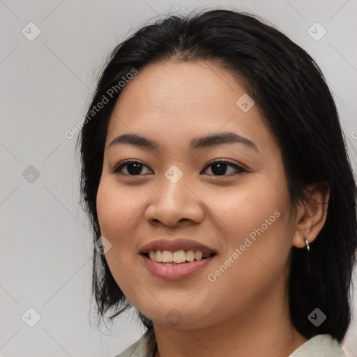 Joyful asian young-adult female with medium  black hair and brown eyes