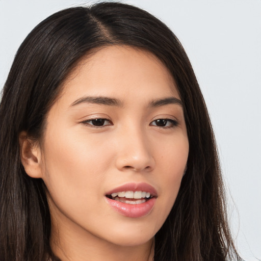 Joyful asian young-adult female with long  brown hair and brown eyes