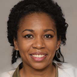 Joyful black young-adult female with medium  brown hair and brown eyes