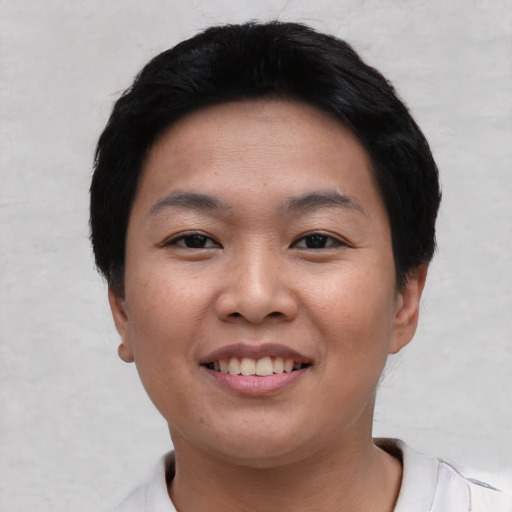 Joyful asian young-adult female with short  black hair and brown eyes