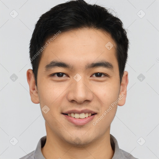 Joyful asian young-adult male with short  black hair and brown eyes