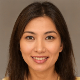 Joyful white young-adult female with long  brown hair and brown eyes