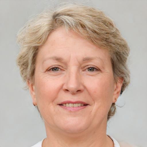 Joyful white middle-aged female with medium  brown hair and blue eyes