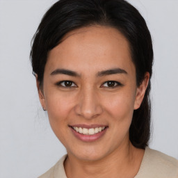 Joyful asian young-adult female with medium  brown hair and brown eyes