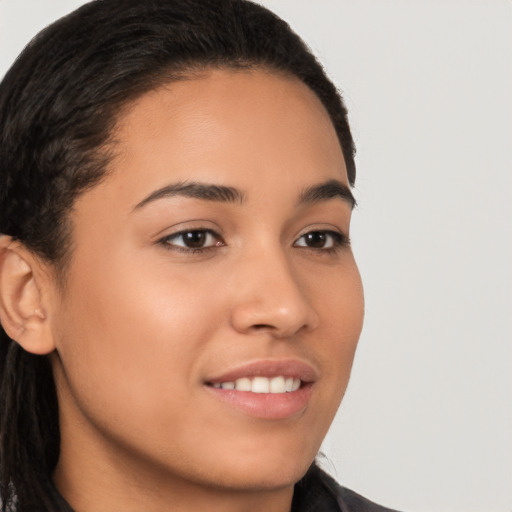 Joyful latino young-adult female with long  brown hair and brown eyes