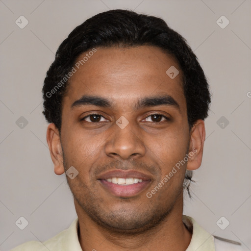 Joyful black young-adult male with short  black hair and brown eyes