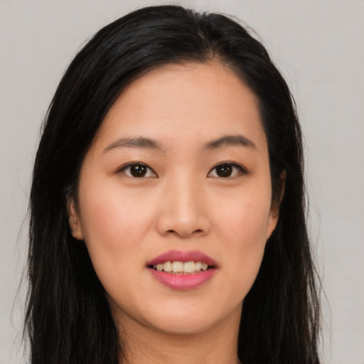 Joyful asian young-adult female with long  black hair and brown eyes