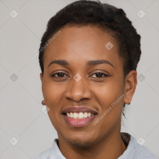 Joyful black young-adult female with short  black hair and brown eyes