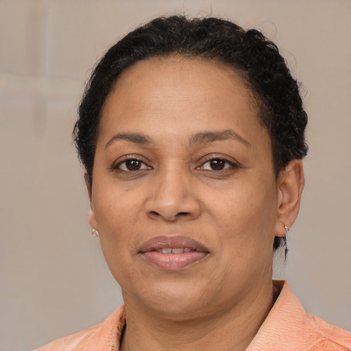 Joyful latino adult female with short  brown hair and brown eyes