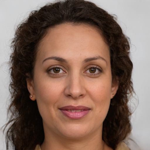 Joyful white adult female with long  brown hair and brown eyes