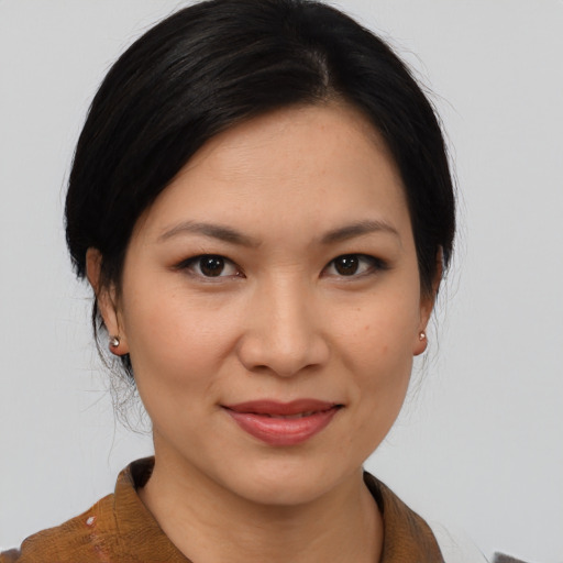 Joyful asian young-adult female with medium  brown hair and brown eyes