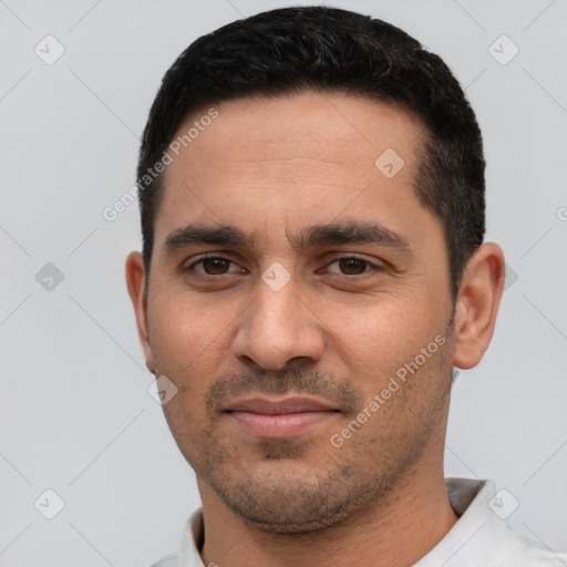 Joyful white young-adult male with short  black hair and brown eyes