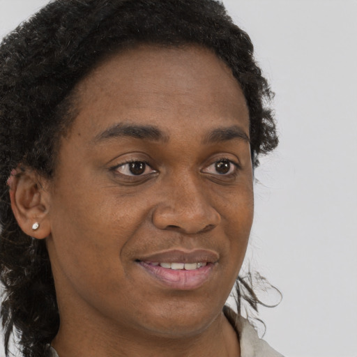 Joyful black young-adult male with short  brown hair and brown eyes