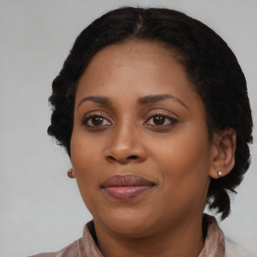 Joyful black young-adult female with medium  black hair and brown eyes