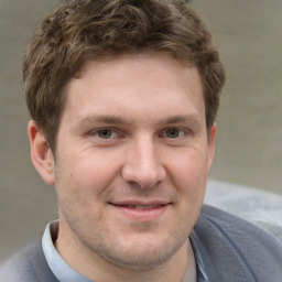 Joyful white adult male with short  brown hair and grey eyes