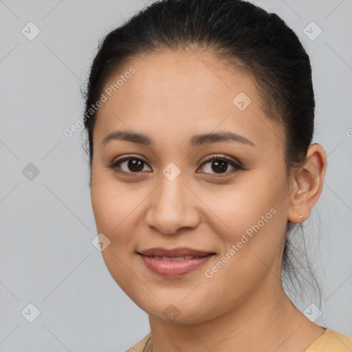 Joyful latino young-adult female with long  brown hair and brown eyes