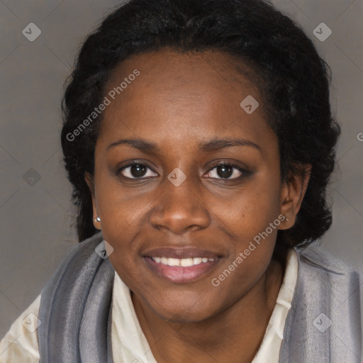 Joyful black young-adult female with long  black hair and brown eyes