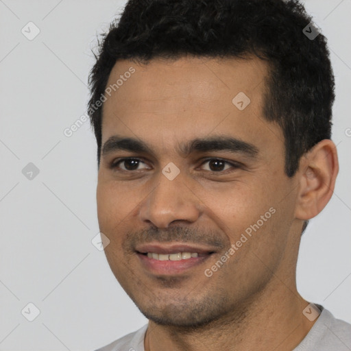 Joyful white young-adult male with short  black hair and brown eyes