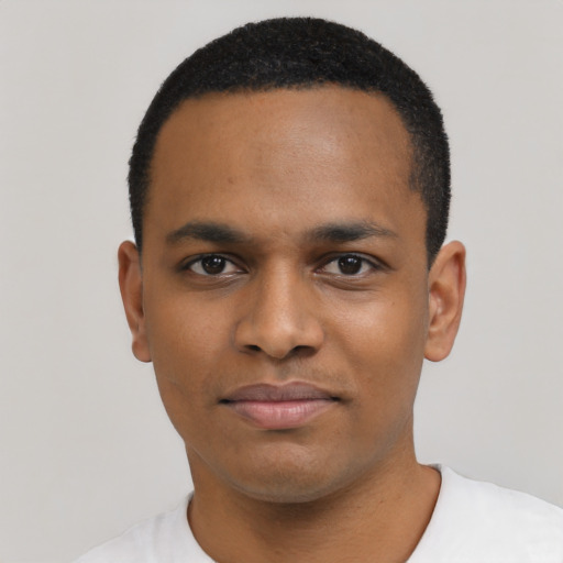 Joyful black young-adult male with short  black hair and brown eyes