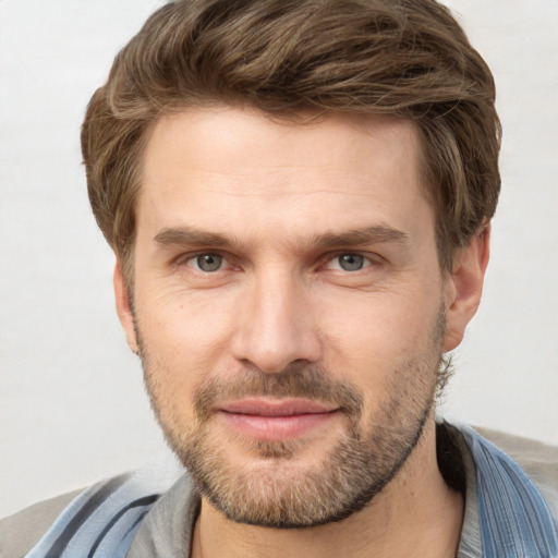 Joyful white adult male with short  brown hair and grey eyes