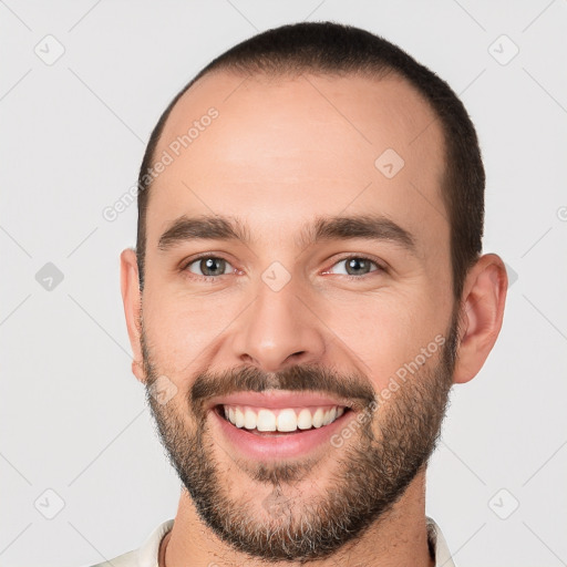 Joyful white young-adult male with short  brown hair and brown eyes