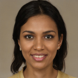 Joyful black young-adult female with medium  brown hair and brown eyes